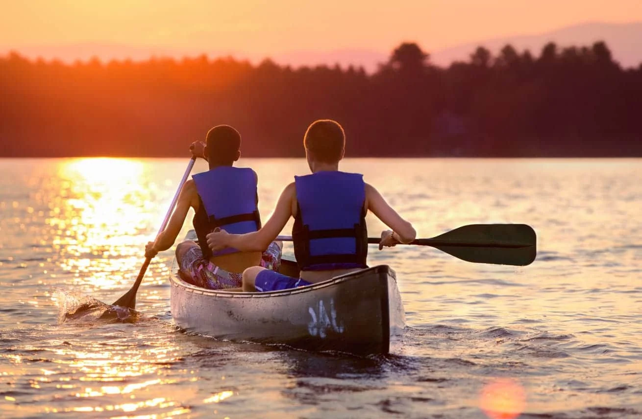 Canoes on the water at sunset