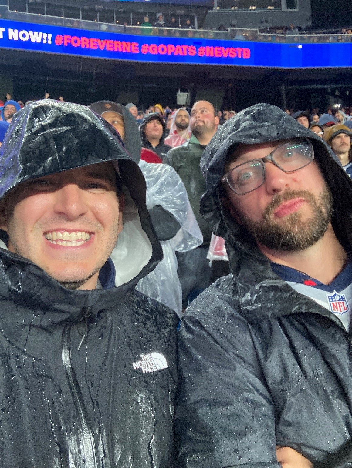 Mike and Craig together at a rainy Patriots game