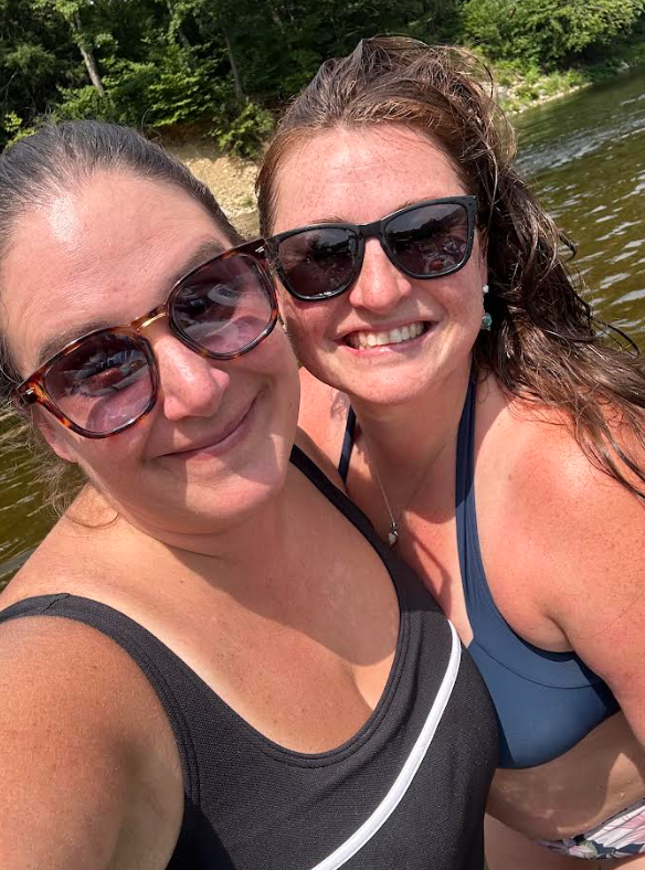 Jami and Kerry-Ann smiling together by the water