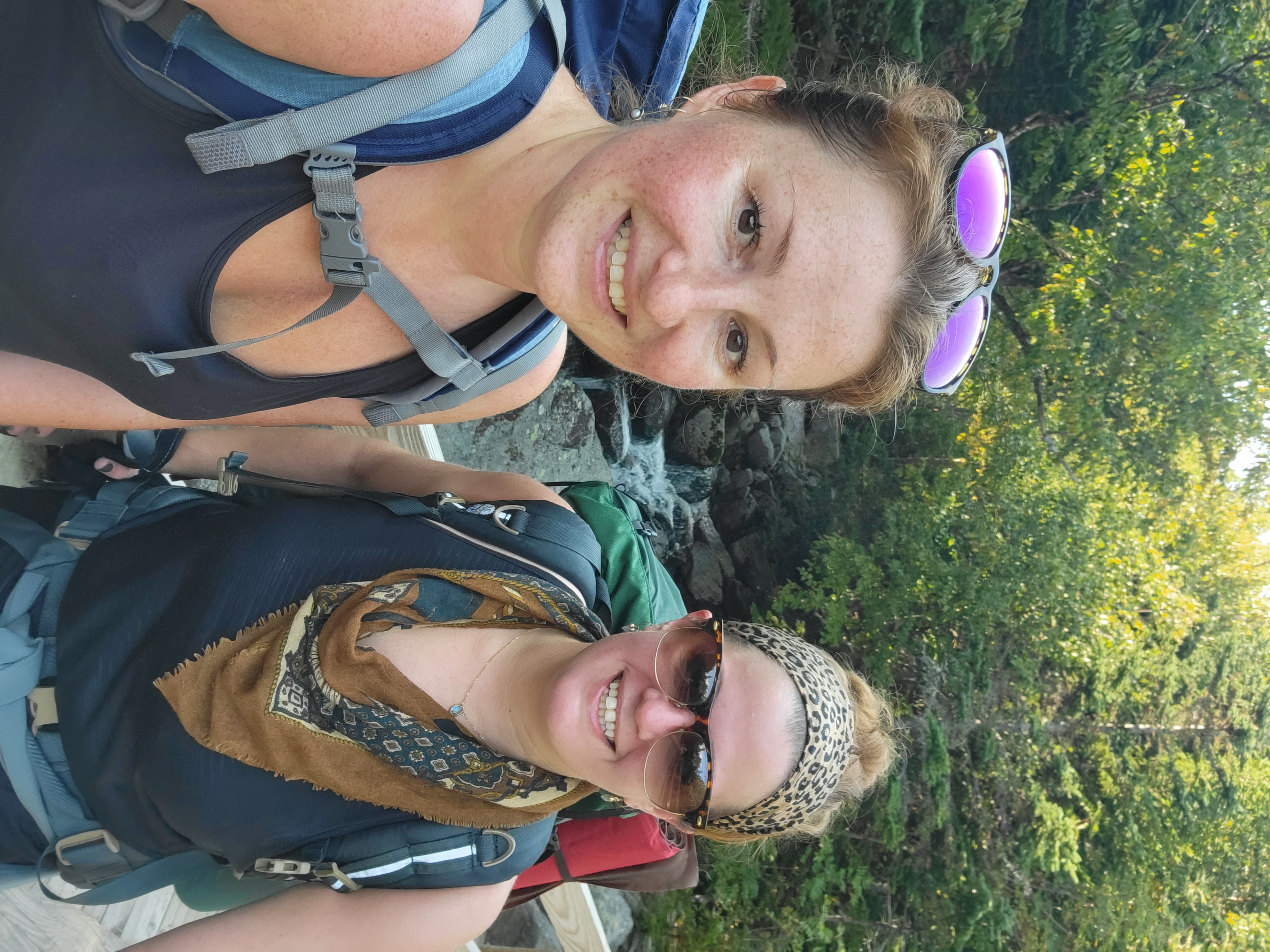 Kristy and Jami hiking together near a waterfall